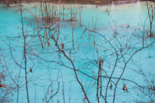 Turquoise waste lake contaminated with gold and copper mining residuals - Stock Photo - Images