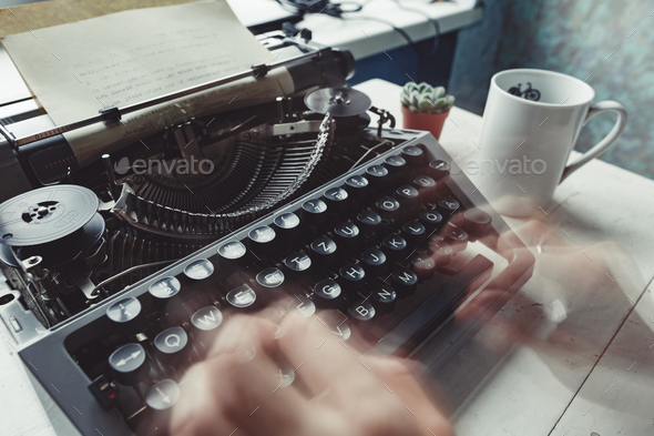 Writer typing with retro writing machine. Stock Photo by KonstantinKolosov