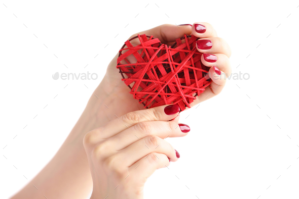Wicker red heart in woman's hands on white background. Closeup h - Stock Photo - Images