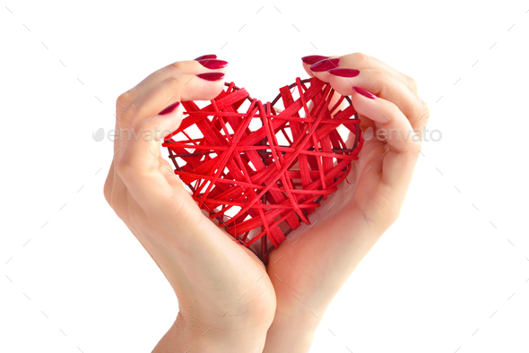 Wicker red heart in woman's hands on white background. Closeup h - Stock Photo - Images