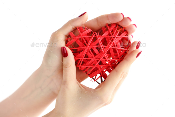 Wicker red heart in woman's hands on white background. Closeup h - Stock Photo - Images