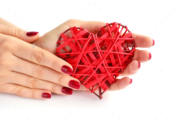 Wicker red heart in woman's hands on white background. Closeup h - Stock Photo - Images