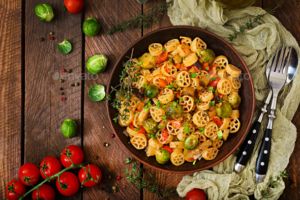 Vegetarian Vegetable pasta Rocchetti with brussels sprouts, tomato, eggplant - Stock Photo - Images