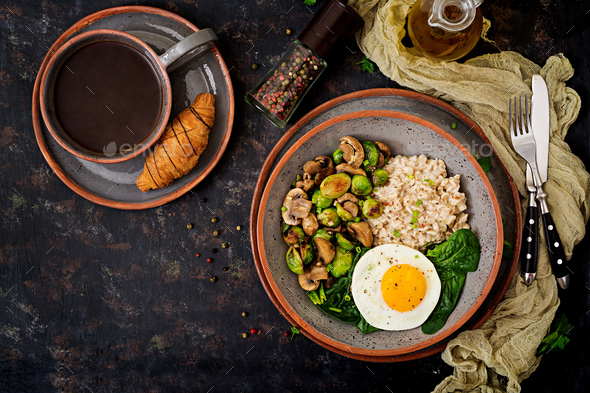 Oat porridge, egg and salad of baked vegetables - mushrooms and Brussels sprouts. - Stock Photo - Images