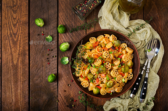 Vegetarian Vegetable pasta Rocchetti with brussels sprouts, tomato, eggplant and paprika - Stock Photo - Images