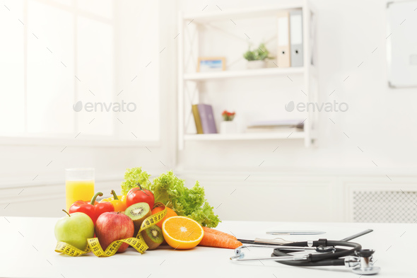 Nutritionist desk with fruit and stethoscope - Stock Photo - Images