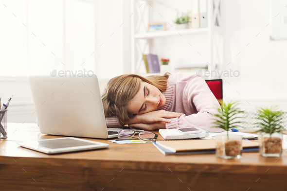 Sleeping overworking business woman at office