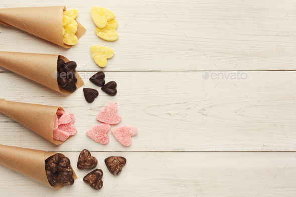 Lovers day background with various sweets in craft cornets - Stock Photo - Images