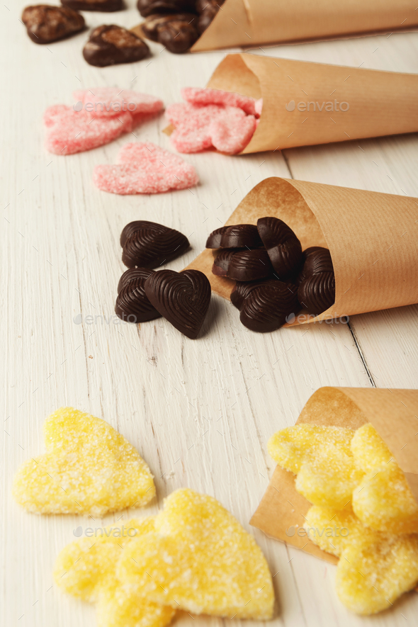 Lovers day background with various sweets in craft cornets - Stock Photo - Images