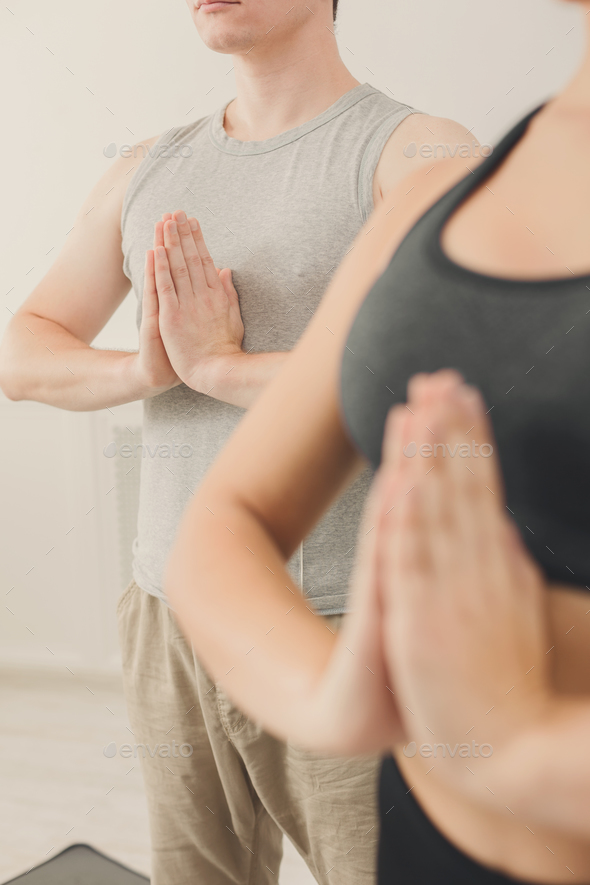 Young couple practicing yoga sitting in padmasana - Stock Photo - Images