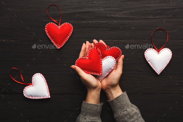 Valentine day background, pillow hearts in female hands - Stock Photo - Images