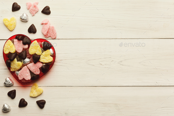 Lovers day background with various sweets in craft cornets - Stock Photo - Images