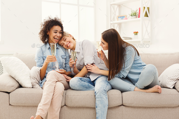 Friends chatting with wineglasses at home - Stock Photo - Images