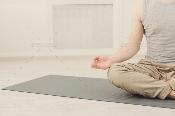 Young man in yoga class, relax meditation pose Stock Photo by Milkosx