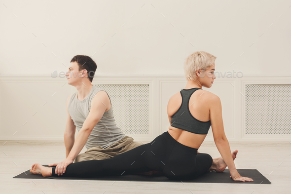 Young couple practicing yoga together in studio - Stock Photo - Images
