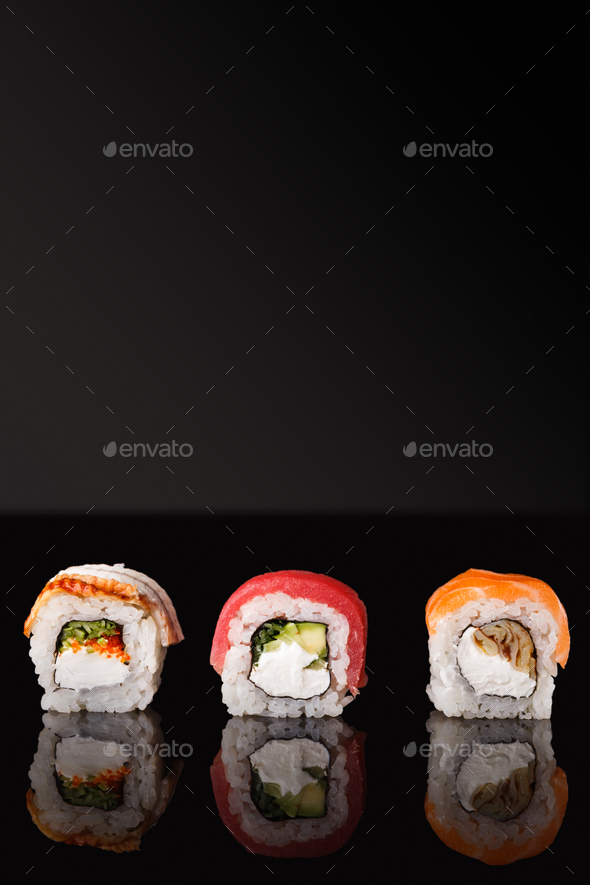 Japanese rolls on black mirroring background - Stock Photo - Images