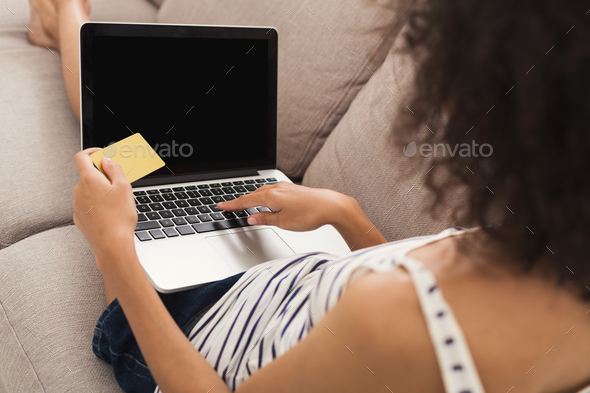 Woman shopping online with credit card back view - Stock Photo - Images