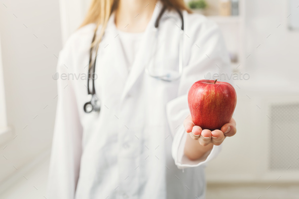 Unrecognizable nutritionist woman with apple - Stock Photo - Images