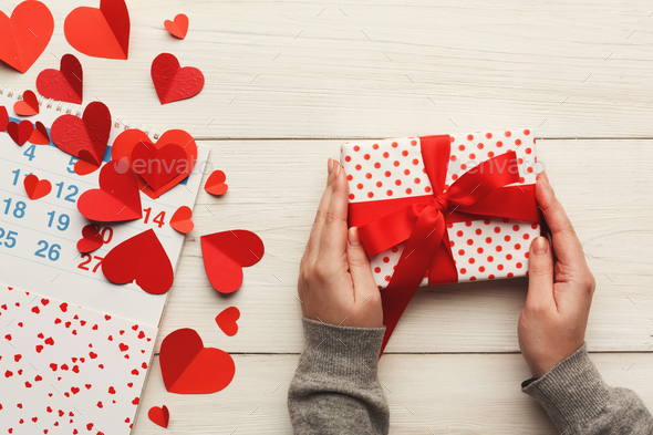 Valentine day background, gift box and hearts on white wood - Stock Photo - Images