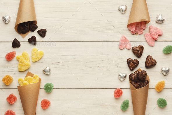 Lovers day background with various sweets in craft cornets - Stock Photo - Images