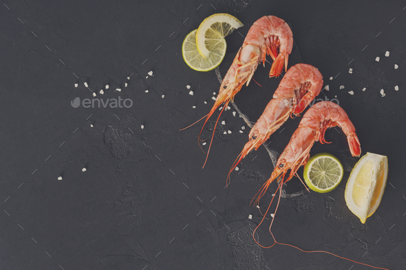Shrimps with salt and lemon on black background - Stock Photo - Images
