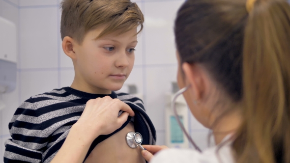 Doctor With Stethoscope Examining School Boy By ABCvideo VideoHive