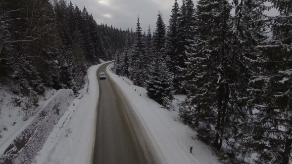 Car Driving on Winter Country Road in Snowy Forest, Aerial View From ...