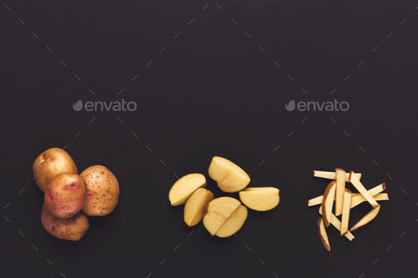Whole and cut potato on black isolated background - Stock Photo - Images