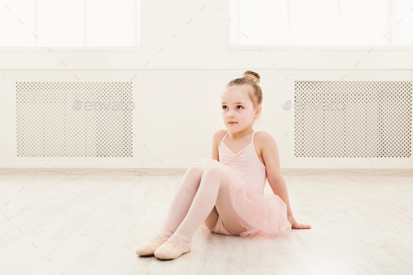 Portrait of little ballerina on floor, copy space - Stock Photo - Images
