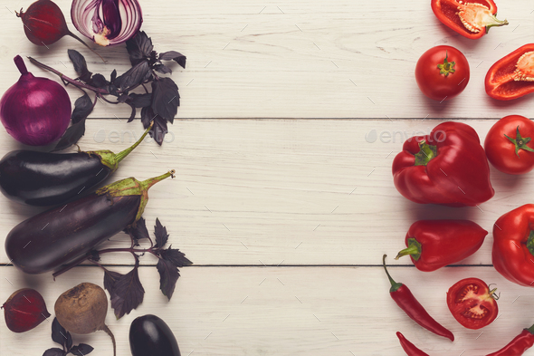 Border of various red and violet vegetables on white wood - Stock Photo - Images