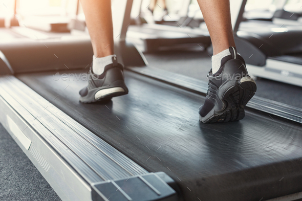 Man's feet on treadmill in fitness club, healthy lifestyle - Stock Photo - Images