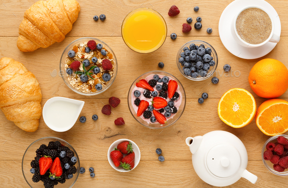 Continental breakfast with croissants and berries on natural wood - Stock Photo - Images