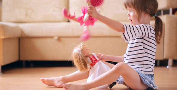 Little Girl Playing With a Dolls