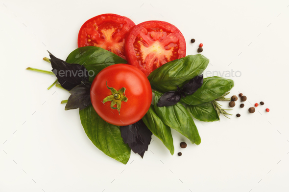 Red tomatoes and basil leaves isolated on white - Stock Photo - Images