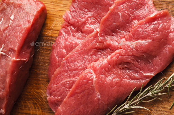 Raw beef filet mignon steaks on wooden board - Stock Photo - Images