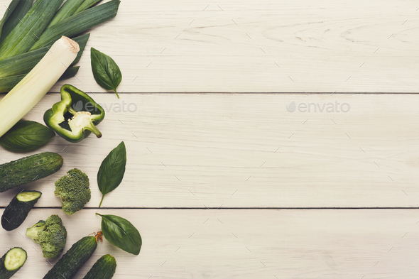 Border of various green vegetables on white wood - Stock Photo - Images