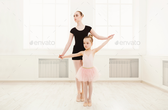 Little girl learn ballet with teacher copy space - Stock Photo - Images