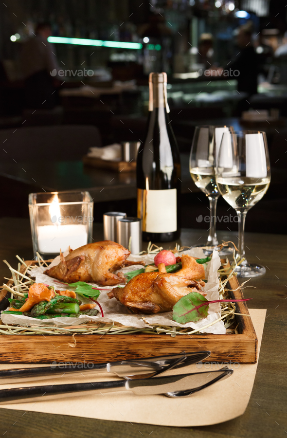 Dinner for two. Quails baked with asparagus and chanterelles - Stock Photo - Images