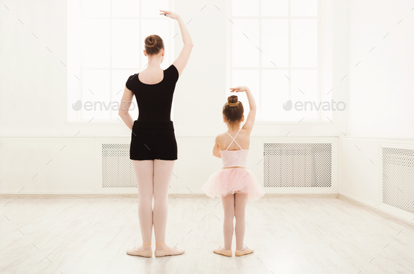 Mastery Start Tilslutte Little girl learn ballet with teacher copy space Stock Photo by  Prostock-studio