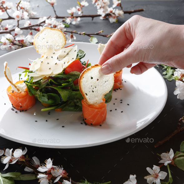 Eating restaurant dish on white plate on black background, closeup - Stock Photo - Images