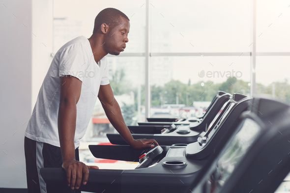 Young man in gym run on treadmill - Stock Photo - Images
