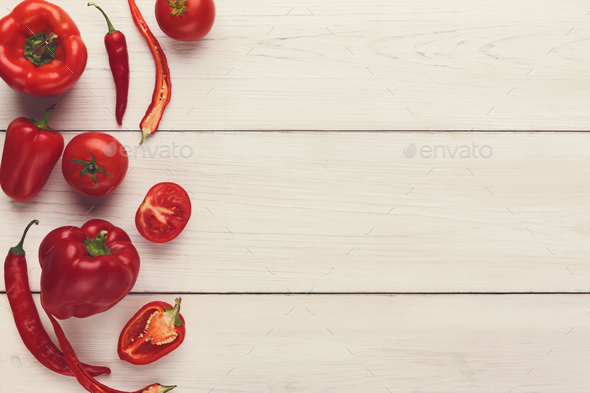 Border of various red vegetables on white wood - Stock Photo - Images