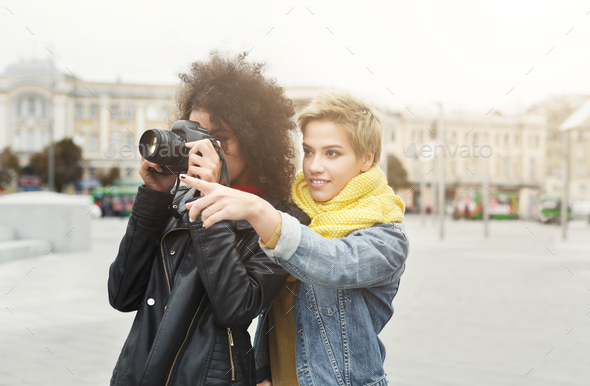 Happy girls with smartphone outdoors in the park - Stock Photo - Images