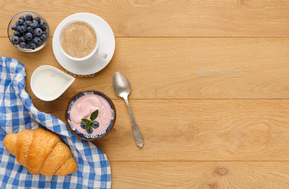 Continental breakfast with croissants and berries on natural wood - Stock Photo - Images