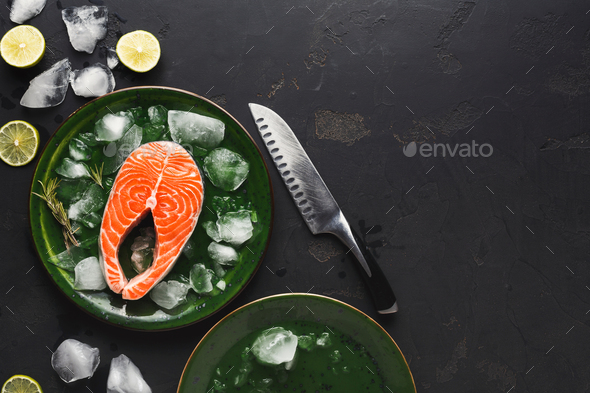 Fresh salmon in green plate at dark background - Stock Photo - Images