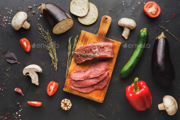 Raw beef filet mignon steaks on wooden board - Stock Photo - Images