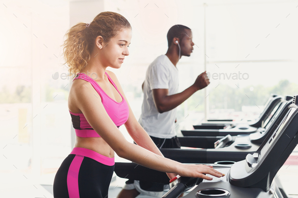 Man and woman, couple in gym on treadmills Stock Photo by Milkosx | PhotoDune