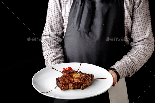 Waiter offering delicious restaurant dish - Stock Photo - Images