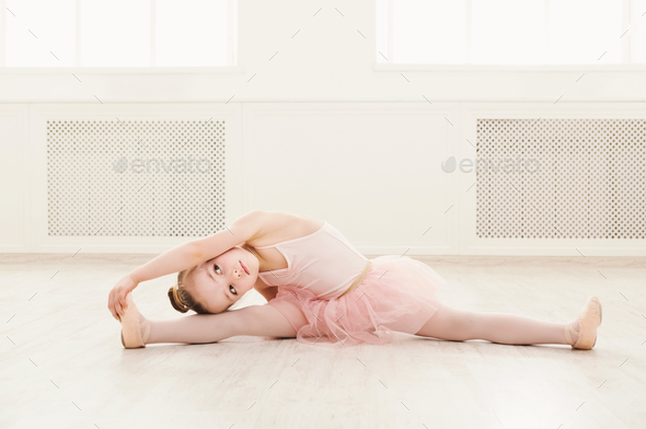 Portrait of little ballerina on floor, copy space - Stock Photo - Images