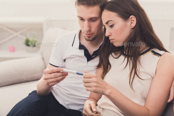 Sad couple after pregnancy test result copy space Stock Photo by Milkosx